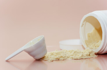 Open container with colostrum powder with measuring scoop. Colostrum benefits for immune system and...