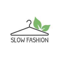Hanger with green leaves and  text slow fashion. Label, badge or logo. Slow fashion icon. Vector illustration