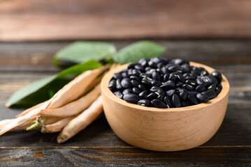 Black kidney bean seed in bowl on wooden background