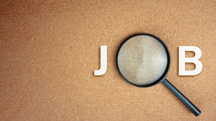 Top view of Magnifier glass searching job on cork board with empty space for text.