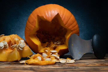 Halloween pumpkin gutting before carving Jack-o'-lantern. Guts and seeds inside a pumpkin being...