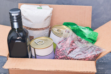 Foodstuff for donation. Various food, pasta, cooking oil and canned food in cardboard box. charity...