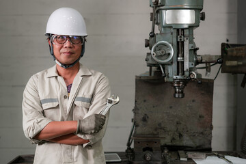 Engineer Holding a Tool,Asian Female,Engineer Standing Beside Machine