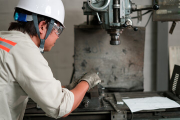 engineer or factory worker using vernier calipers for finding to set machine control panel in factory