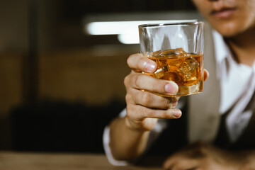 The bartender serves whiskey to customers at a bar or restaurant.