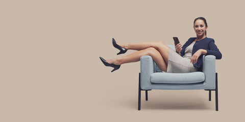 Confident businesswoman sitting with feet up