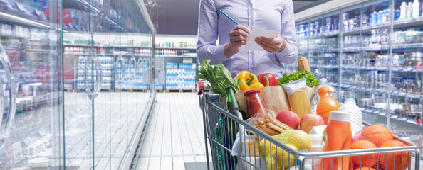 Woman doing grocery shopping at the supermarket