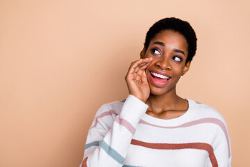 Photo of sweet young short hairdo guy talk secret wear sweater isolated on beige color background