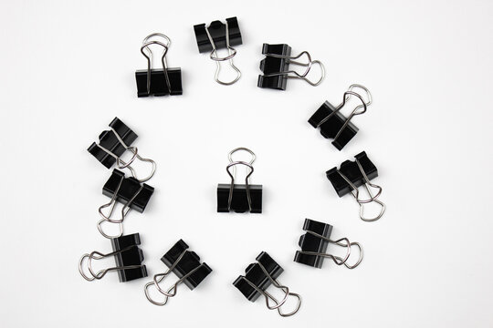 Stationery metal clips on an isolated white background.Paper clips,accessories.