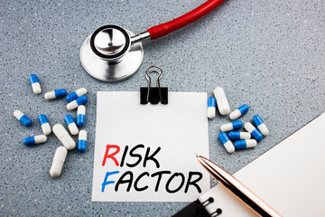 Disease risk factor concept. The inscription RISK FACTOR next to drugs and a stethoscope. Medical...