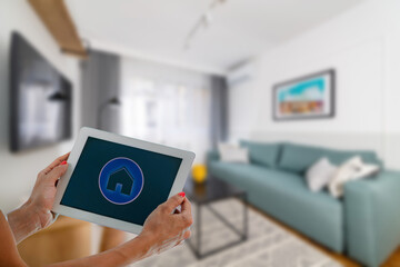 Smart Home App on a Tablet. Woman Controlling Appliances at Home.