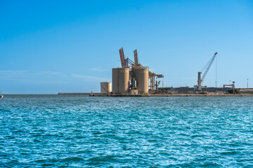 Naklejka premium Landscape of the port of Malaga with ciment silo and docks.