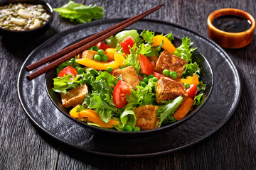 tofu salad with greens and vegetables in bowl