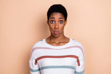 Photo of tricky shocked young unisex person wear sweater big eyes lips pouted isolated beige color...