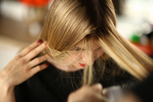 Young Blonde Woman Demonstrates Regrown Hair Roots