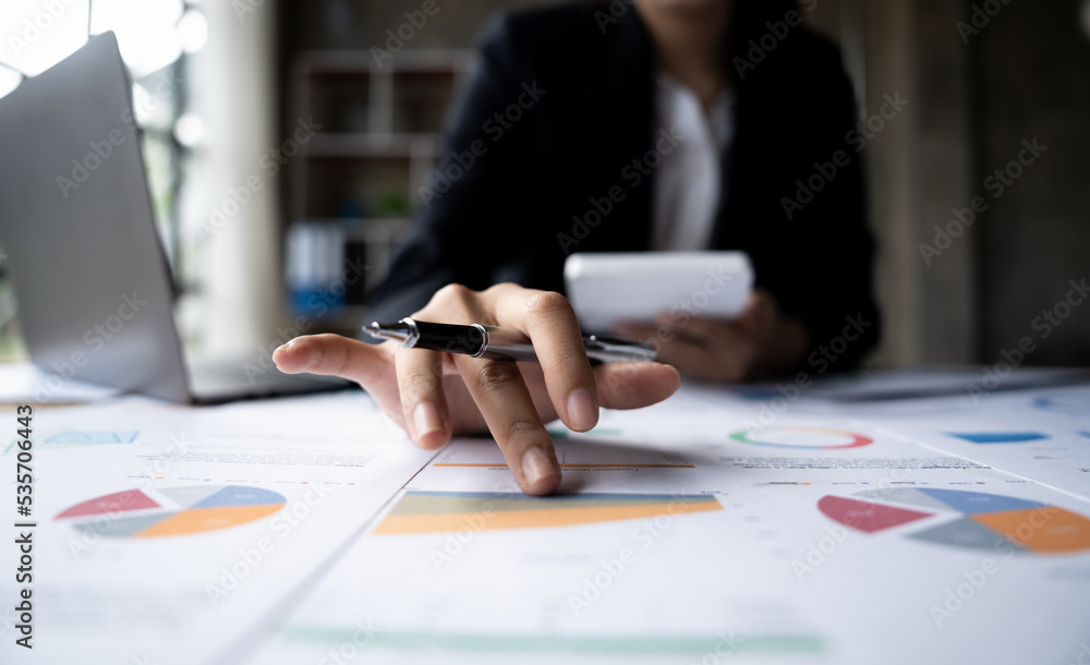 Poster business woman pointing turnover with graph chart report and use calculator for analysis data.