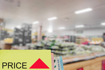 Sign price and growing up graph, Shop or supermarket shelfs out of focus. Basic food and goods rising price due to economic crisis concept. Increase in cost of living theme.