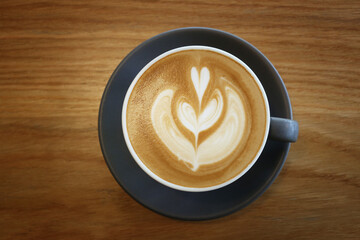 Latte art,Coffee mug placed on a table in a cafe.