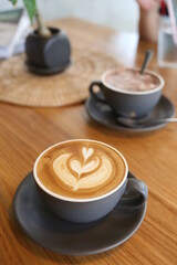 Coffee mugs placed on a table in a coffee shop.