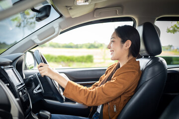 Young beautiful asian women getting new car. she very happy and excited. Smiling female driving...