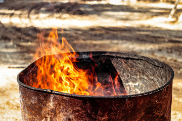 Burning fire in a barrel close-up. Bright flame. Open flame heating. Problems with heating and gas.