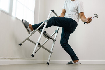 Carpenter falling down from ladder head hit the ground and fainted. Accident at home careless