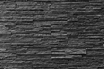 Black stone wall Texture in weathered and have natural surfaces.