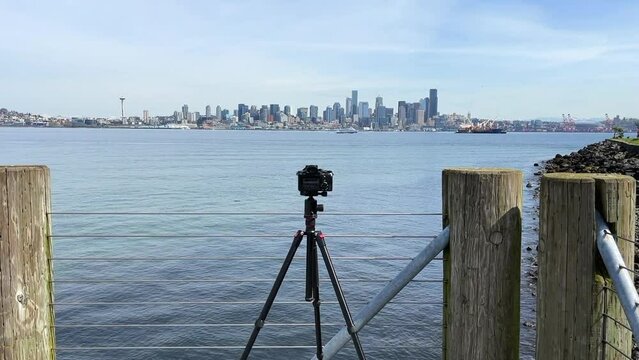 Camera On Tripod At Luna Park Viewpoint In Seattle, Washington With Cityscape View Across Elliott Bay. wide, dolly shot