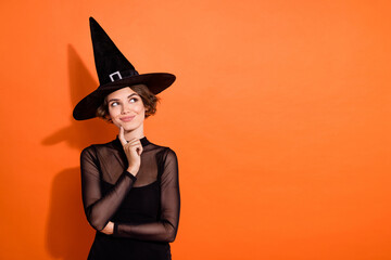 Photo of pretty tricky lady wear black witch dress cap finger chin looking empty space isolated...