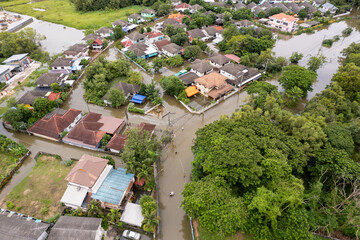 Fototapeta na wymiar High-angle view of the Great Flood, Meng District, Thailand, on October 3, 2022, is a photograph from real flooding. With a slight color adjustment 