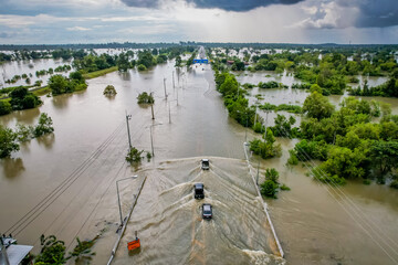 High-angle view of the Great Flood, Meng District, Thailand, on October 3, 2022, is a photograph from real flooding. With a slight color adjustment
 - obrazy, fototapety, plakaty