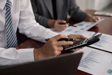 Fototapeta premium Two business leaders talk about charts, financial graphs showing results are analyzing and calculating planning strategies, business success building processes