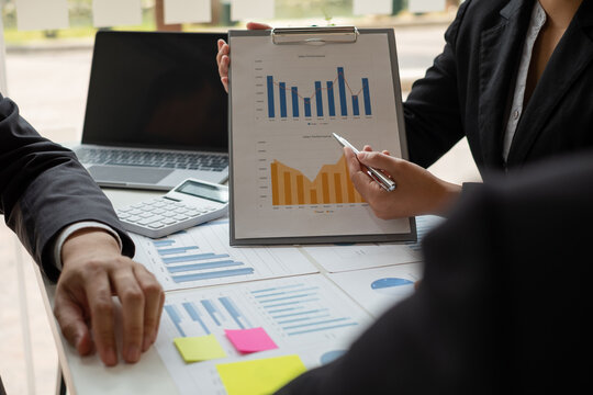 Business leaders talk about charts, financial graphs showing results are analyzing and calculating planning strategies, business success building processes