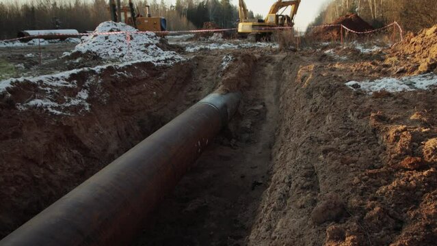 Construction of the main gas pipeline underground. Large long pipe for pumping gas, industry.