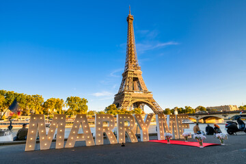 Marriage proposal with the inscription marry me in front of the Eiffel Tower in Paris, France