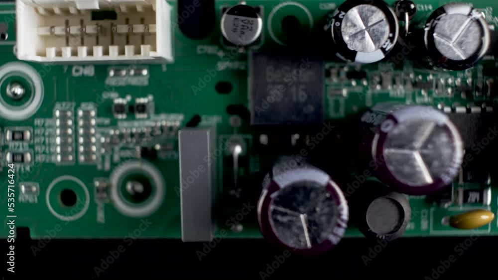Poster a close up dolly shot of a pcb circuit board, a complex piece of hardware which ensures electronic c