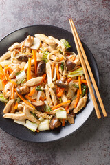 Chop Suey Chicken Stir Fry with vegetables close-up in a plate on the table. Vertical top view from...