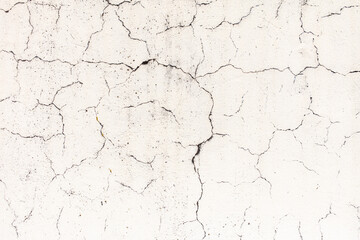Cracked plaster on the wall of the house.