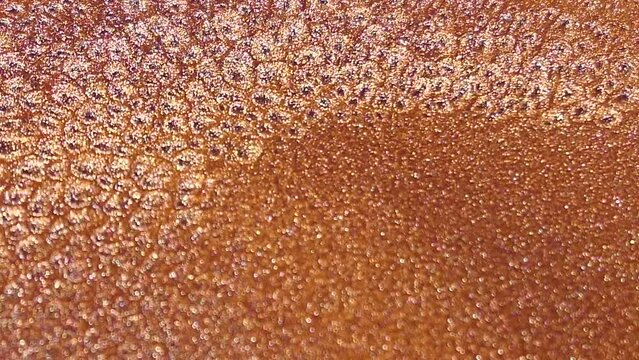 Rust colored shimmering ink wallpaper. Abstract texture background.