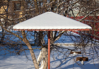 The roof of the gazebo in the snow in winter.