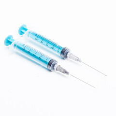 Medical syringe on a white background. A syringe for injection. The concept of health and beauty