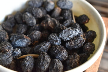 Dried black olives in a white bowl