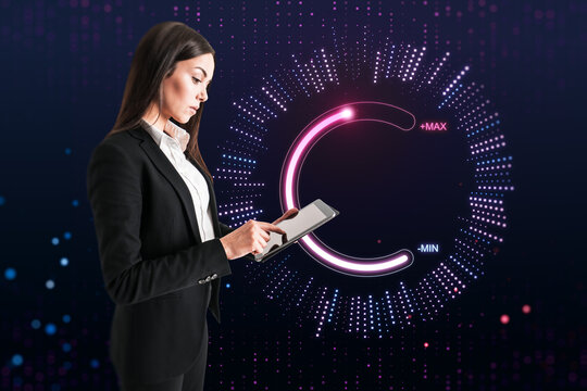 Attractive young european businesswoman using tablet with abstract glowing max and min scale hologram on dark background. Volume control and future concept.