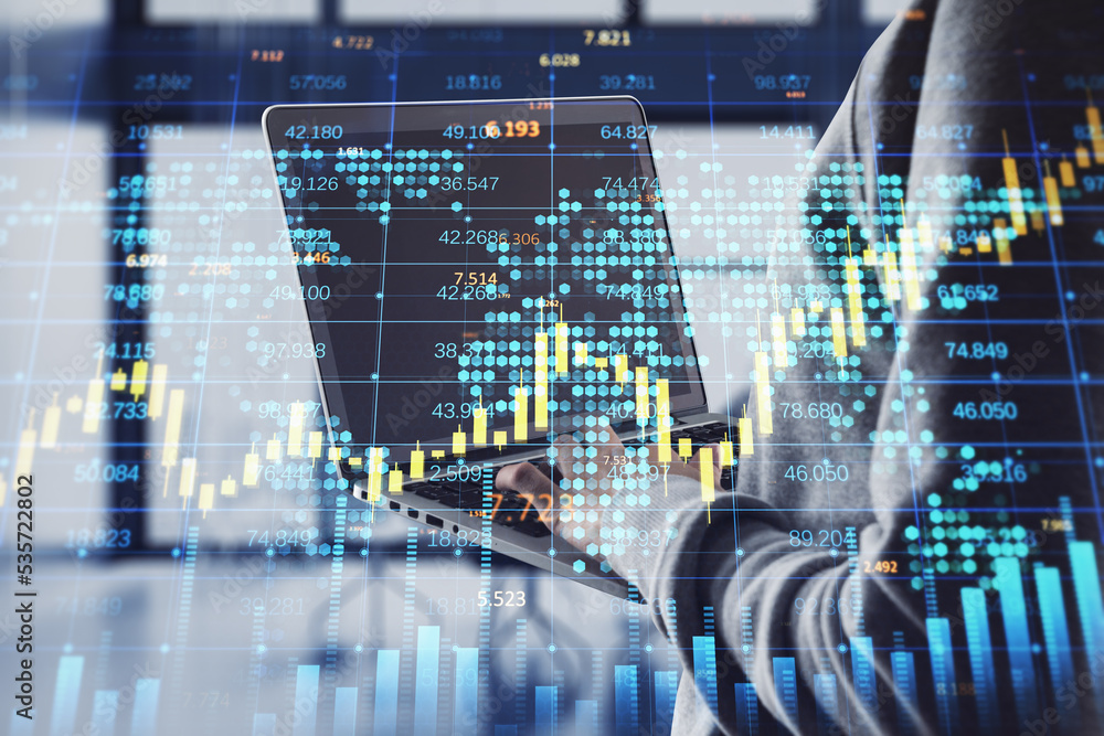 Poster hacker hands using laptop with creative forex chart with candlestick graph, index and tech hologram on blurry office interior background.