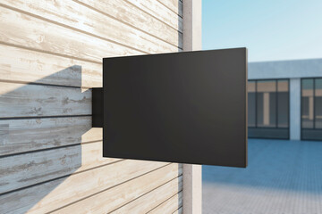 Empty rectangular black stopper on wooden building. Bright city with sunlight background. Ad, pub, cafe, or restaurant banner. Mock up, 3D Rendering.