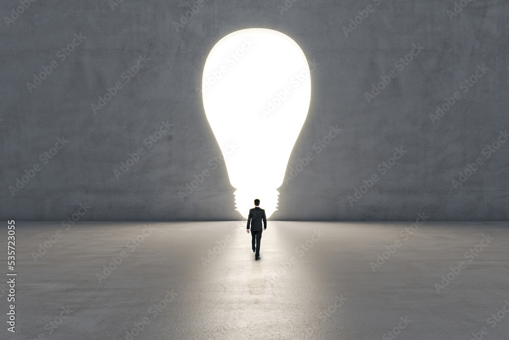 Aufkleber Innovation and creative idea concept with businessman back view goes towards illuminated hole in the form of light bulb on grey background