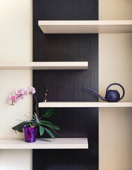 purple orchid in a vase on the shelf in the room