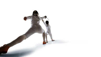 Two female fencing athletes fight isolated on white