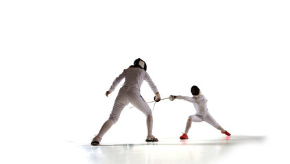 Fototapeta premium Two female fencing athletes fight isolated on white