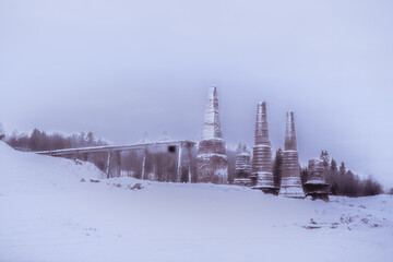 Beautiful landscape of old factory pipes in a winter evening. Karelia. High quality photo